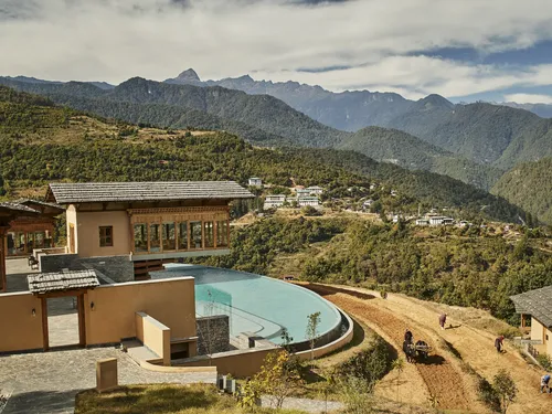 Punakha Bhutan Flying Farmhouse and paddy fields with farmers